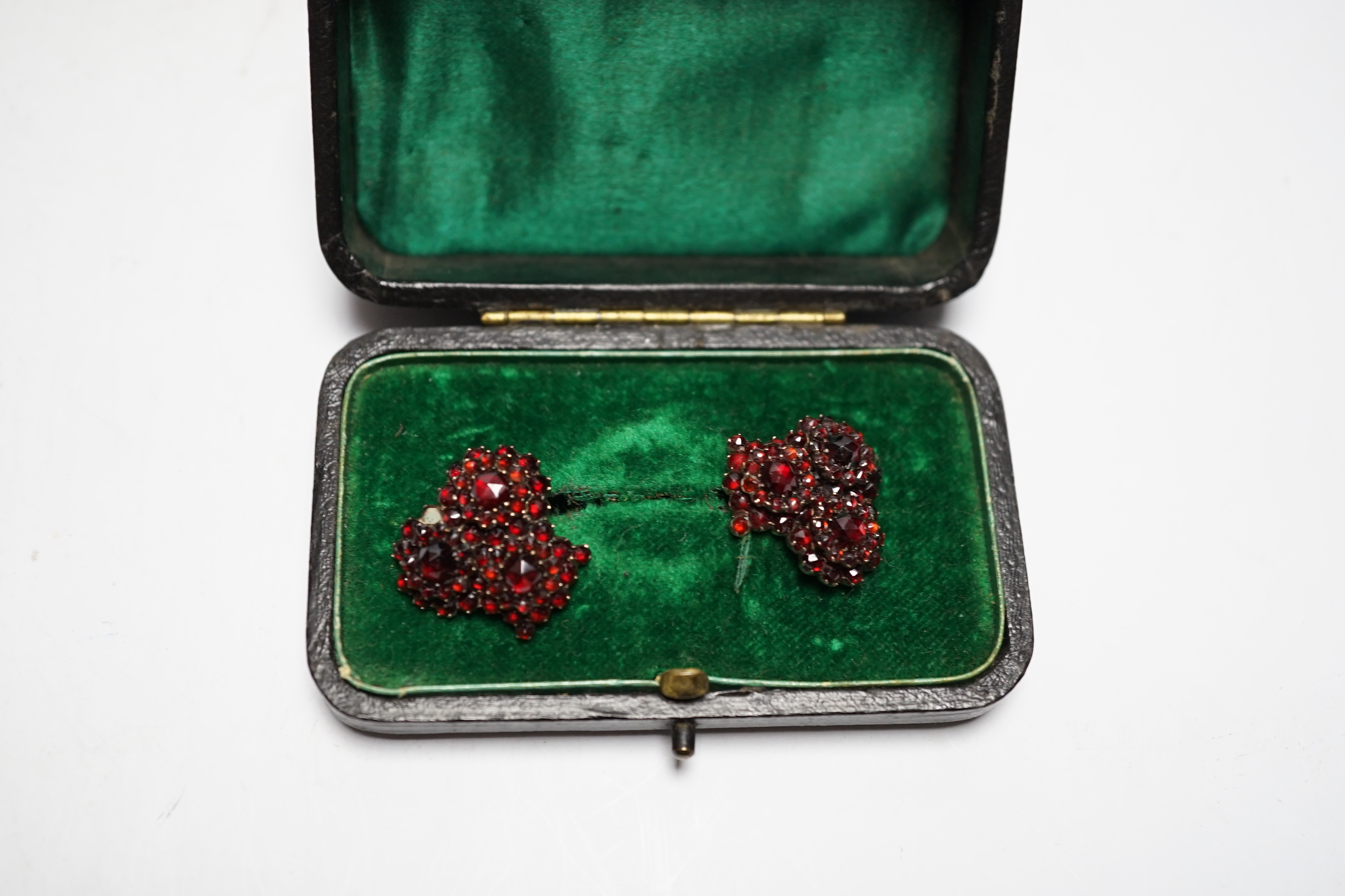 A pair of Edwardian gilt white metal and garnet coloured paste set triple cluster earrings, diameter 18mm.